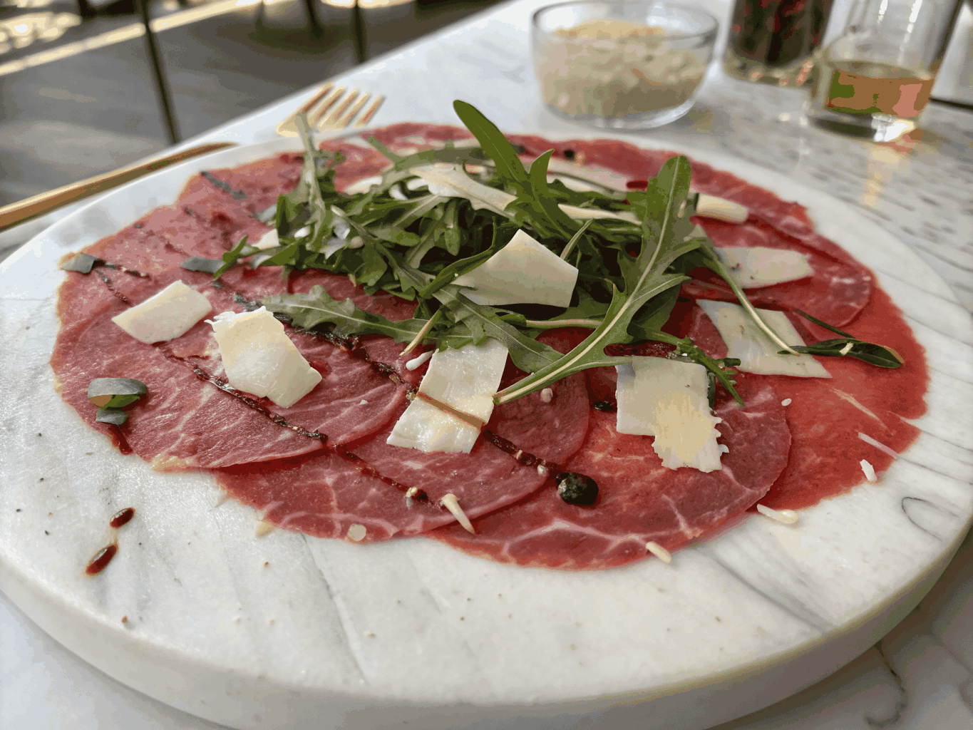 Classic beef carpaccio with shaved pecorino and capers